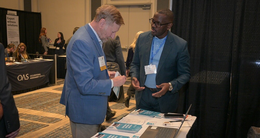 Annual Meeting Image 5 An attendee engaging with a representative at exhibit hall