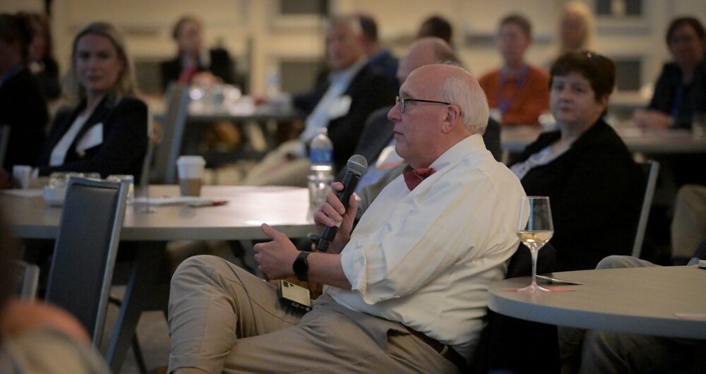 Annual Meeting Image 6 Attendee asking a question in a session